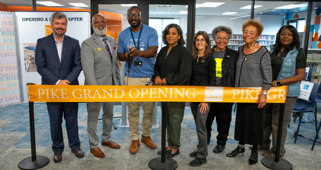 Pike Branch Manager Michael Jenkins cuts the ribbon at the Grand Opening surrounded by Indianapolis Public Library Board of Trustees and the Library's CEO Gregory A. Hill, Sr.