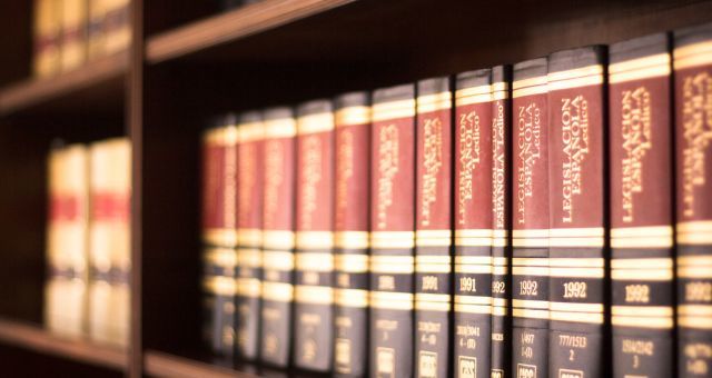 Several shelves of law books on library shelves.