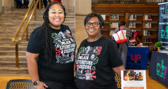 Two Indianapolis Public Library staff members welcome people to the Black Health Fair.