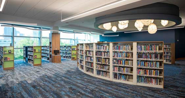 Curved book case full of children's books at Kid Central.