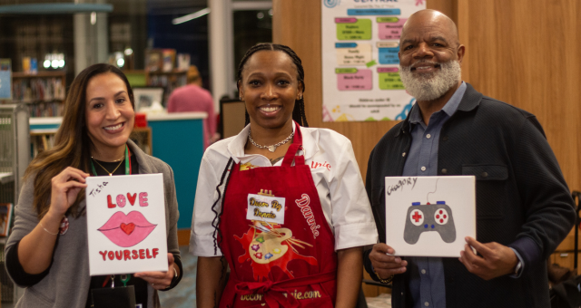 Chief Talent and Development Officer Tisha Galarce, an art presenter, and Chief Executive Officer Gregory A. Hill, Sr. showcasing their artwork during Meet the Artists XXXVIII.