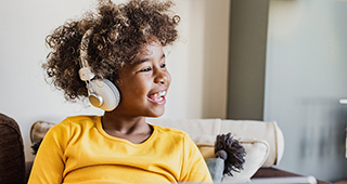 Child listening with headphones