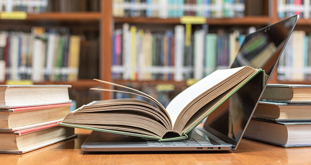 Books and a Laptop on a Library Table