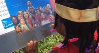 Child reading at a StoryWalk station.