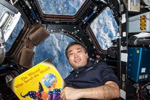 Photo Astronaut Reading at the International Space Station