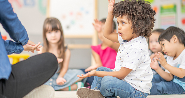 children singing with motions at storytime