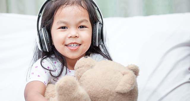 Child listening to headphones