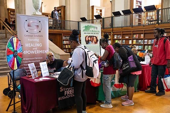 Attendees looking at the various tables of information.