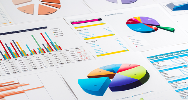 Charts, graphs, and spreadsheets that indicate working on analyzing a budget.