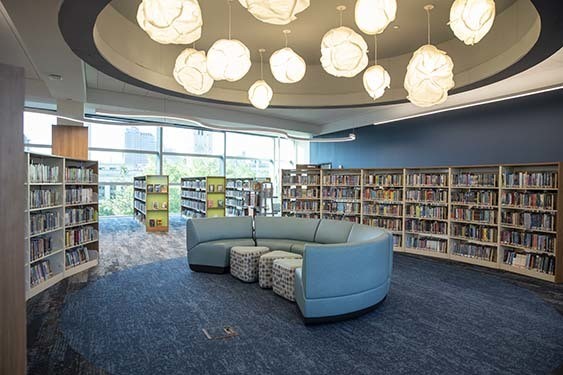 Large blue couch with foot stools at Kid Central.