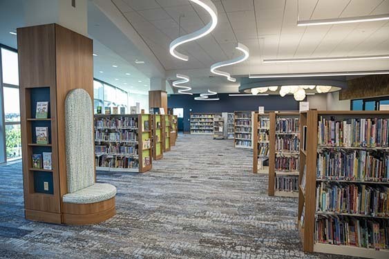 Several tall book cases of children's books at Kid Central.