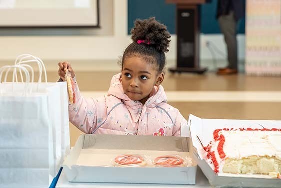 A young patron receives a cookie.