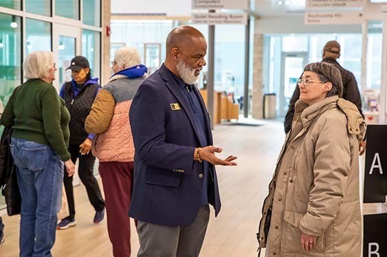 The Indianapolis Public Library’s CEO, Gregory A. Hill, Sr., speaks with a patron.