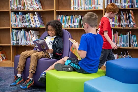 Community Voices Two Boys Looking At Books