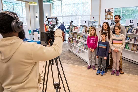 A young family filming a We Love Our Library video spot.